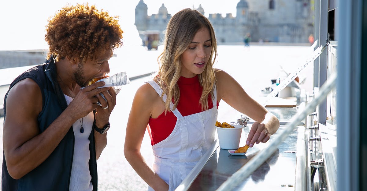Why are my commercial fries going soggy almost immediately? - Woman eating fried potato with sauce standing near black boyfriend biting tasty burger at food truck Why are my commercial fries going soggy almost immediately? - Woman eating fried potato with sauce standing near black boyfriend biting tasty burger at food truck