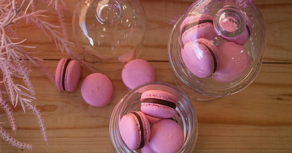 Why are my macarons cracking on top? - Close-Up Shot of Macarons on a White Surface Why are my macarons cracking on top? - Close-Up Shot of Macarons on a White Surface