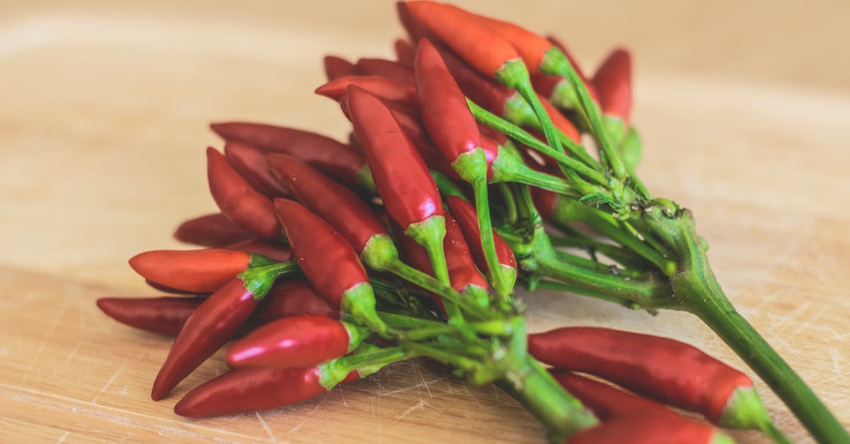 Why are the stems left on when cooking an artichoke? - Red Chili Peppers on Brown Wooden Surface Why are the stems left on when cooking an artichoke? - Red Chili Peppers on Brown Wooden Surface