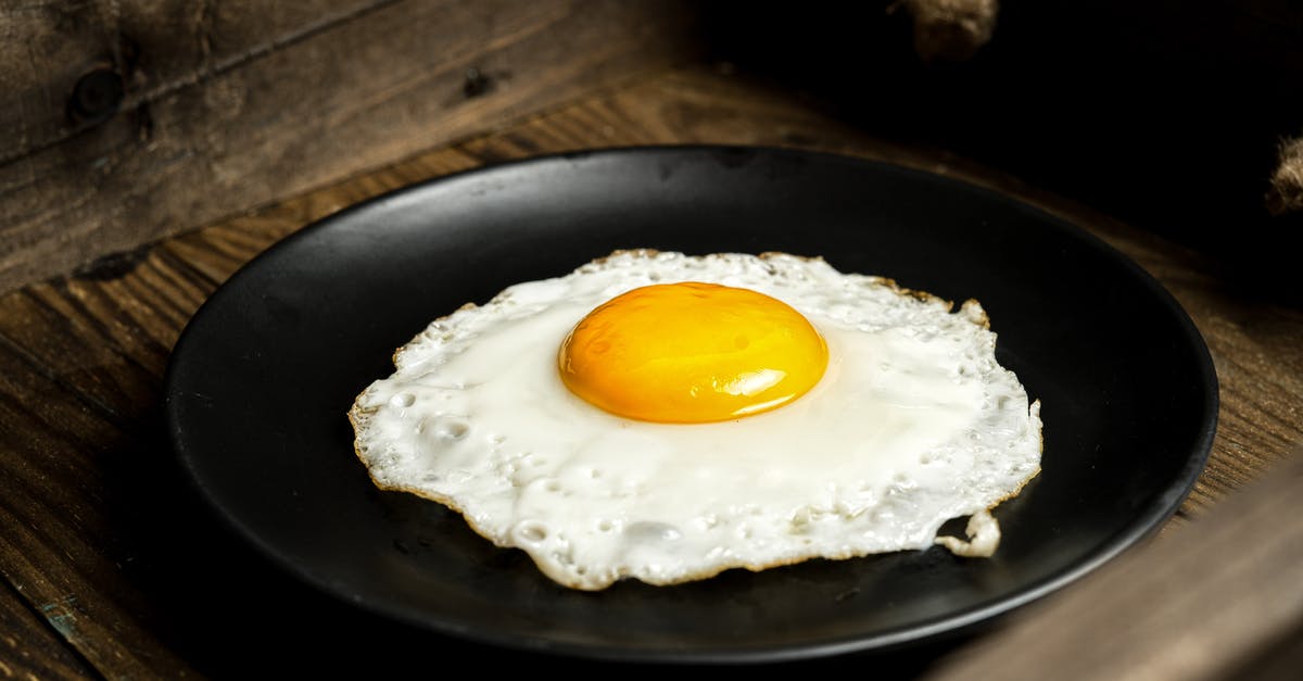 Why are there egg whites over my yolk when I try to make a sunny side up fried egg? - Close-Up Photo of a Sunny Side Up Egg on a Black Plate Why are there egg whites over my yolk when I try to make a sunny side up fried egg? - Close-Up Photo of a Sunny Side Up Egg on a Black Plate
