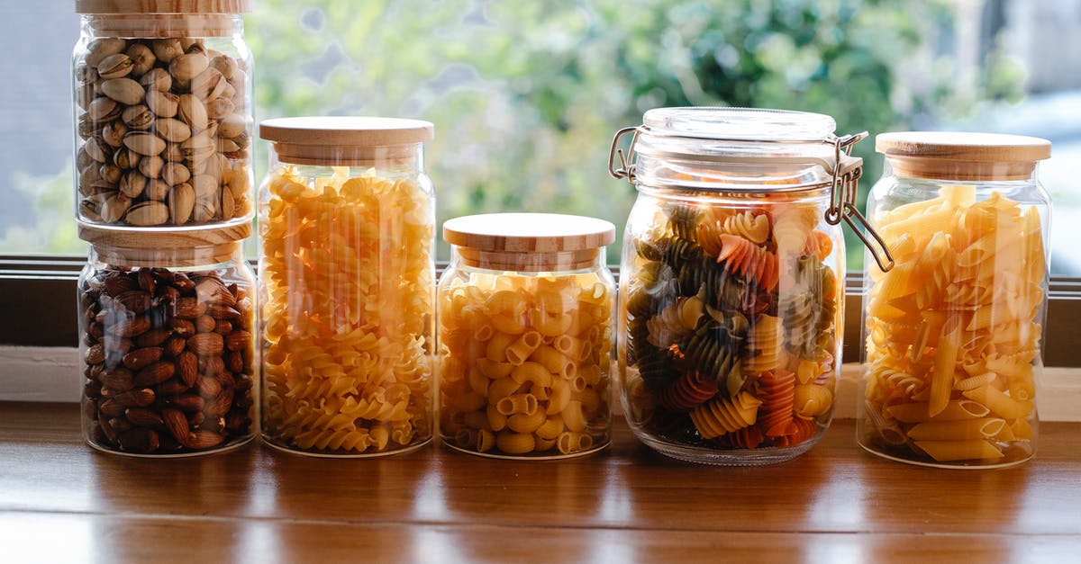 Why are there so many different pasta shapes? - Glass jars filled with assorted types of uncooked pasta and pistachios with almonds placed on wooden table near window in light room Why are there so many different pasta shapes? - Glass jars filled with assorted types of uncooked pasta and pistachios with almonds placed on wooden table near window in light room