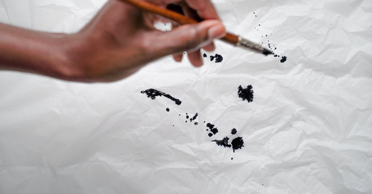 Why are there white spots appearing on segments of canned tangerines? - Ink Spots on Wrinkly Paper and Hand with Pen Why are there white spots appearing on segments of canned tangerines? - Ink Spots on Wrinkly Paper and Hand with Pen