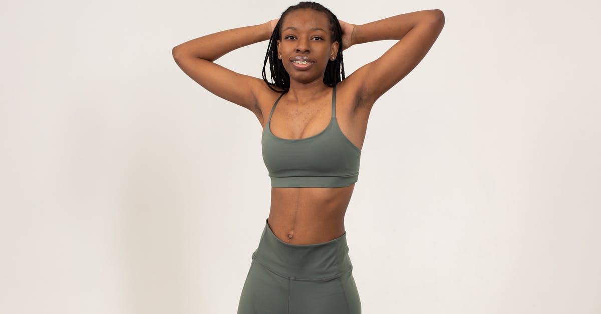 Why are these mushroom stems leaving a long, skinny fiber behind on the cap? - Positive slim African American female with hands on head wearing sports bra and leggings smiling and looking at camera Why are these mushroom stems leaving a long, skinny fiber behind on the cap? - Positive slim African American female with hands on head wearing sports bra and leggings smiling and looking at camera