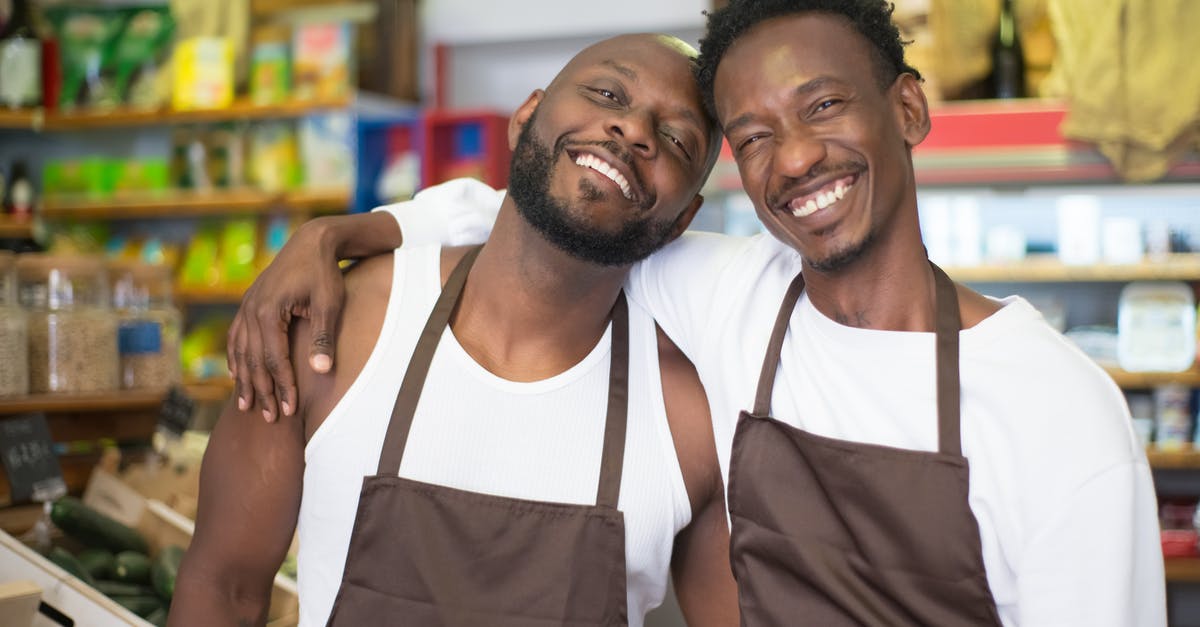 Why are vegetables often left unrefrigerated at the grocery store? - Men Smiling Together while in a Grocery Why are vegetables often left unrefrigerated at the grocery store? - Men Smiling Together while in a Grocery