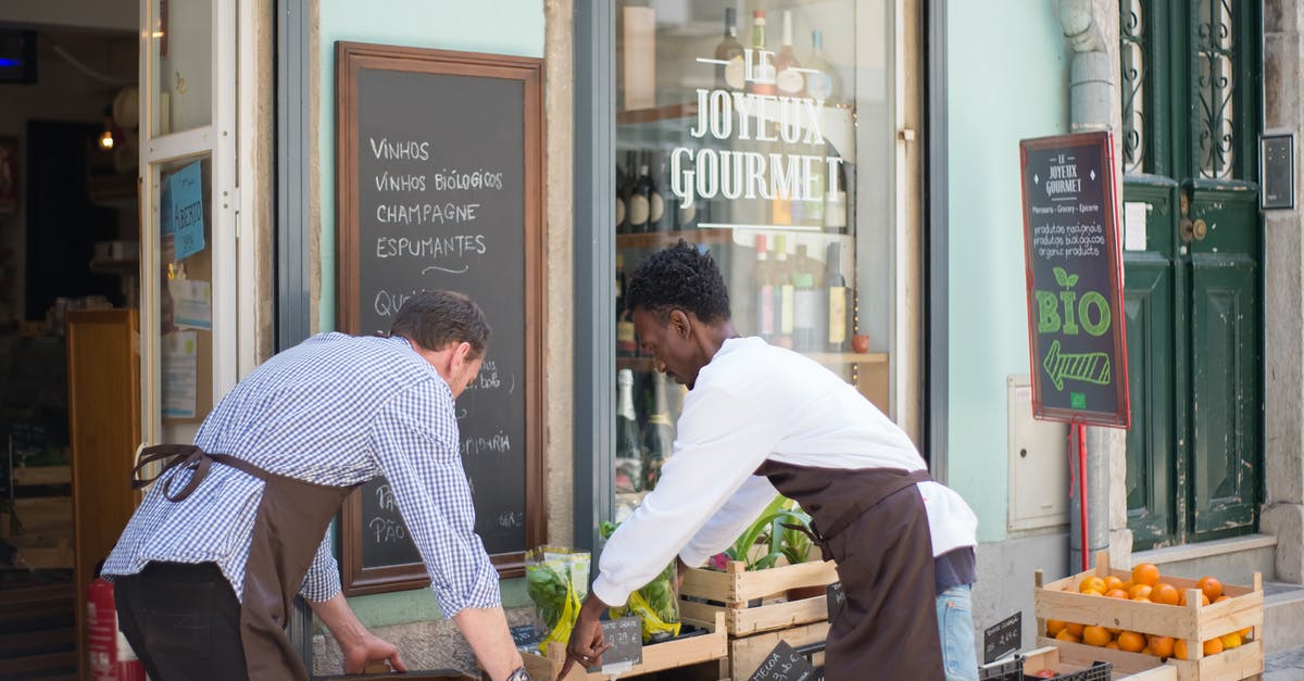 Why are vegetables often left unrefrigerated at the grocery store? - Men Fixing the Products in the Vegetable Stand Why are vegetables often left unrefrigerated at the grocery store? - Men Fixing the Products in the Vegetable Stand