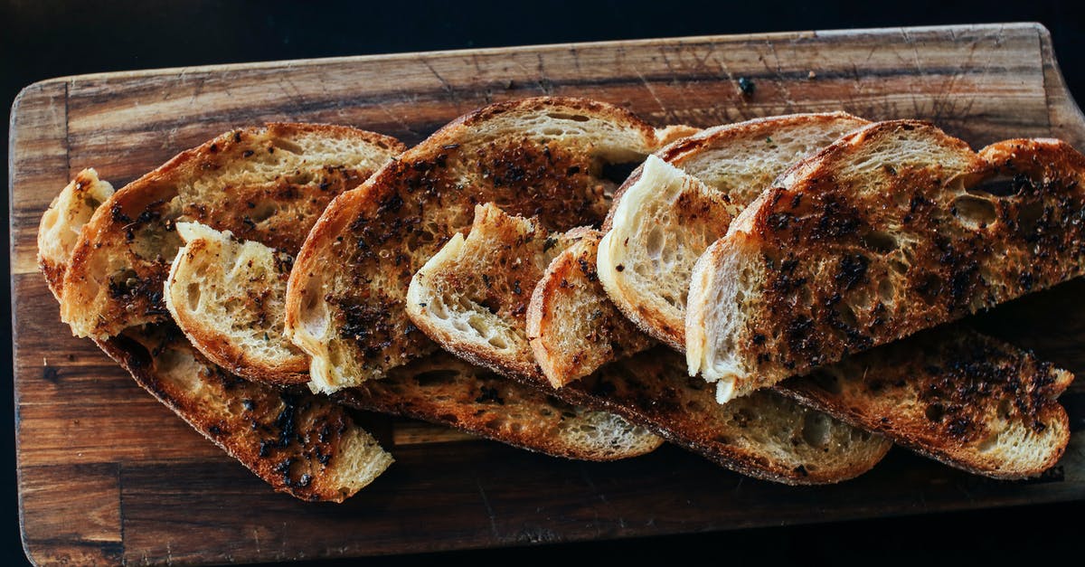 Why baste bread with cornstarch? - Brown Bread on Black Tray Why baste bread with cornstarch? - Brown Bread on Black Tray