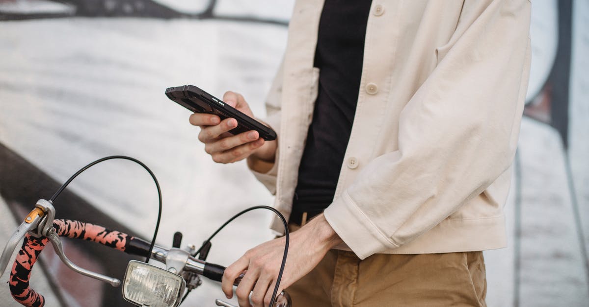 Why boil and cool jam before using it in a cake? - Anonymous man using smartphone while standing on street near bicycle Why boil and cool jam before using it in a cake? - Anonymous man using smartphone while standing on street near bicycle
