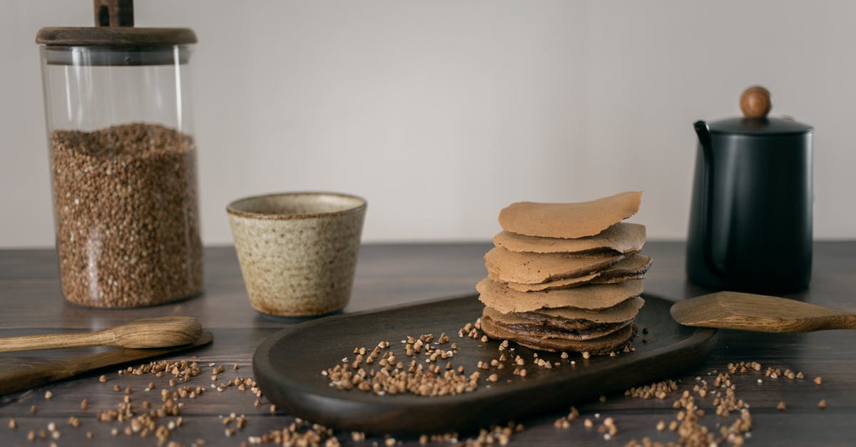 Why Buckwheat Pancakes? - Homemade buckwheat pancakes placed on table with ingredients and utensils Why Buckwheat Pancakes? - Homemade buckwheat pancakes placed on table with ingredients and utensils