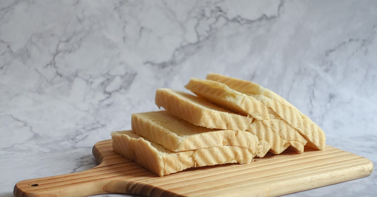 Why did my ceramic coated loaf pan turn brown? - Slice Bread on Brown Chopping Board Why did my ceramic coated loaf pan turn brown? - Slice Bread on Brown Chopping Board