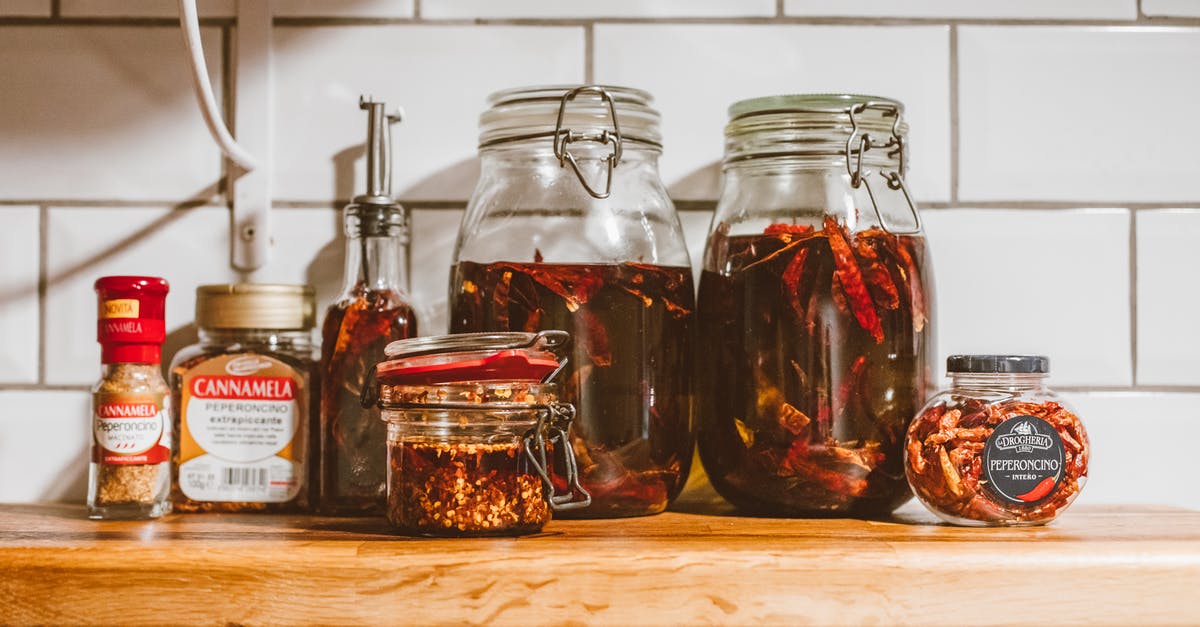 Why did my chili oil flakes split in two layers? - Clear Glass Jars of Condiments on Brown Wooden Shelf Why did my chili oil flakes split in two layers? - Clear Glass Jars of Condiments on Brown Wooden Shelf