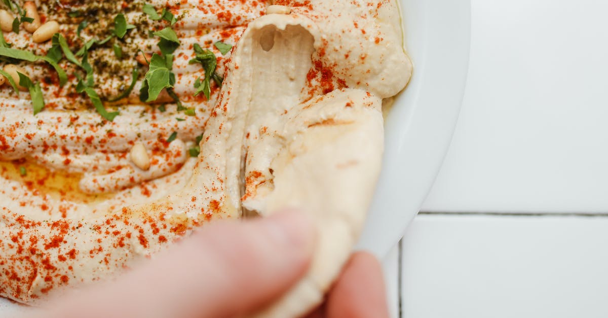 Why did my hummus go bad? - Close-Up Shot of a Person Holding a Humnus Bread Why did my hummus go bad? - Close-Up Shot of a Person Holding a Humnus Bread