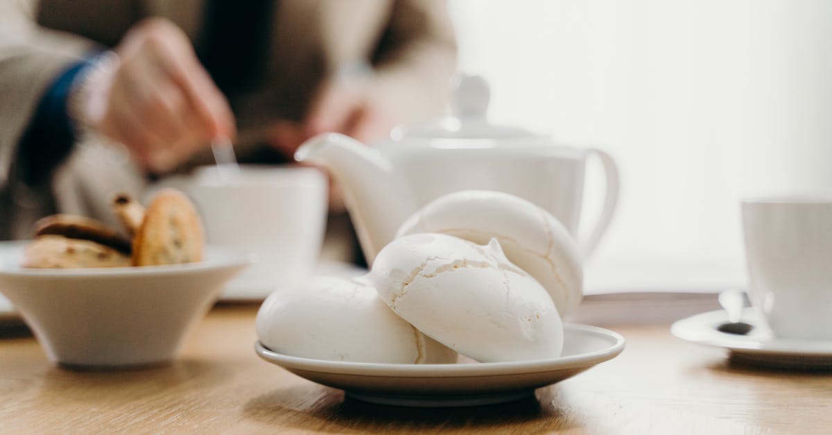 Why did my meringue deflate and go soft? - Crop anonymous businessman drinking tea with cookies in cafe Why did my meringue deflate and go soft? - Crop anonymous businessman drinking tea with cookies in cafe
