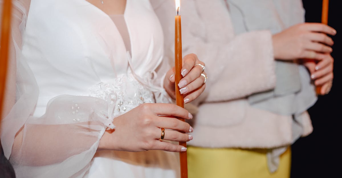 Why did my nougat burn? - Woman in White Dress Holding Brown Stick With White Candle