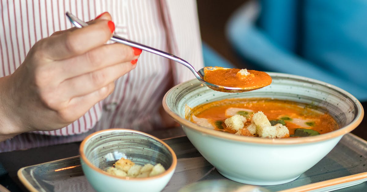 Why did my tomato soup turn thick and brownish? - Person Holding Silver Spoon and White Ceramic Bowl With Soup Why did my tomato soup turn thick and brownish? - Person Holding Silver Spoon and White Ceramic Bowl With Soup