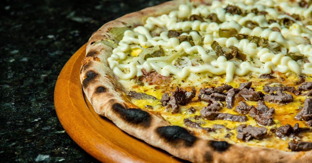 Why didn't the toppings on my pizza stick to the dough? - Pizza With Cheese and Green Leaves Why didn't the toppings on my pizza stick to the dough? - Pizza With Cheese and Green Leaves