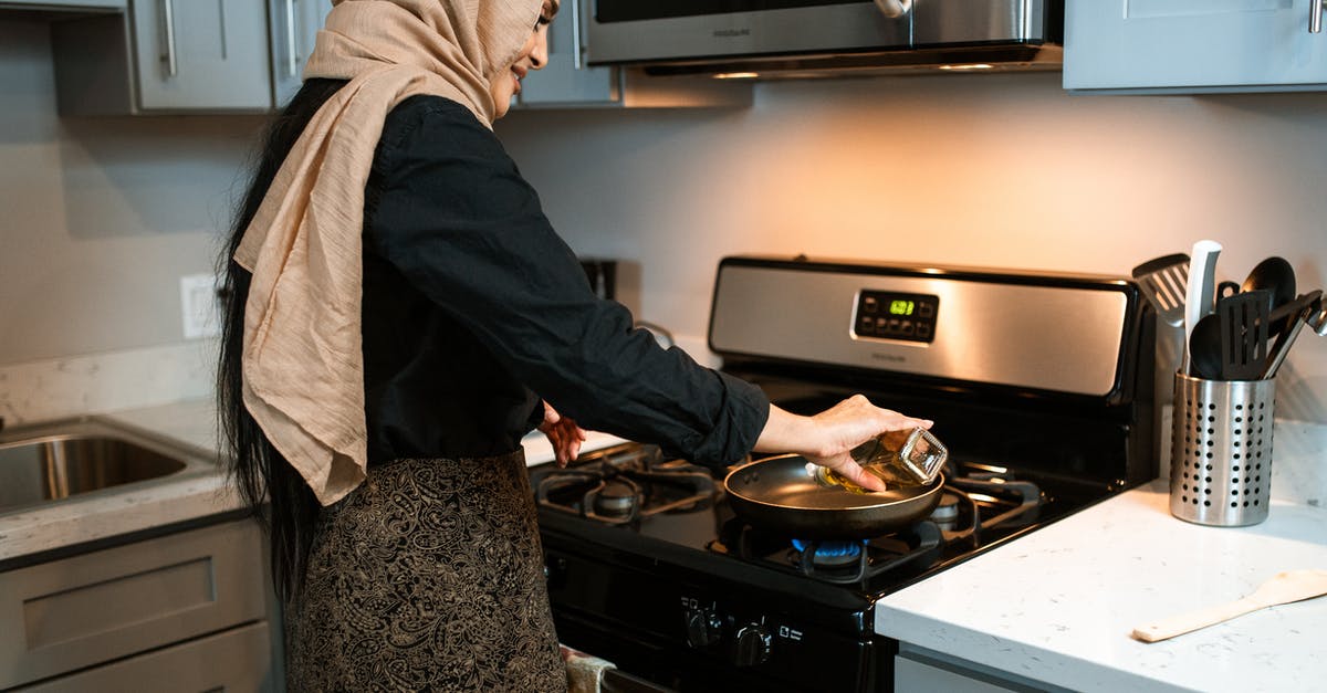 Why do chefs finish with olive oil? - Crop ethnic woman pouring oil on pan Why do chefs finish with olive oil? - Crop ethnic woman pouring oil on pan