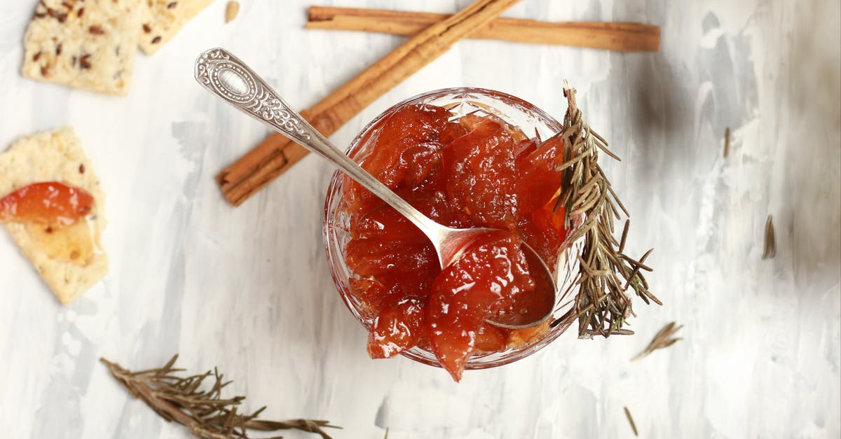 Why do cinnamon sticks taste sweet? - Top view composition of bowl with delicious jam in cup with rosemary sprigs and crispbread with cinnamon sticks