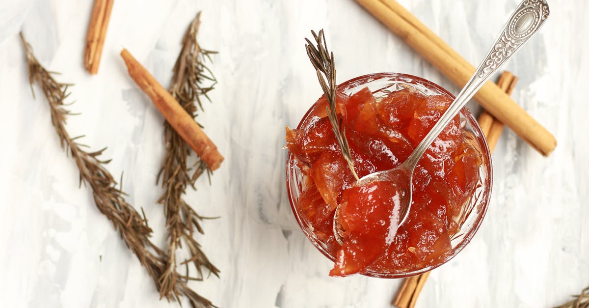Why do cinnamon sticks taste sweet? - Glass bowl of jam with rosemary sprigs and cinnamon sticks