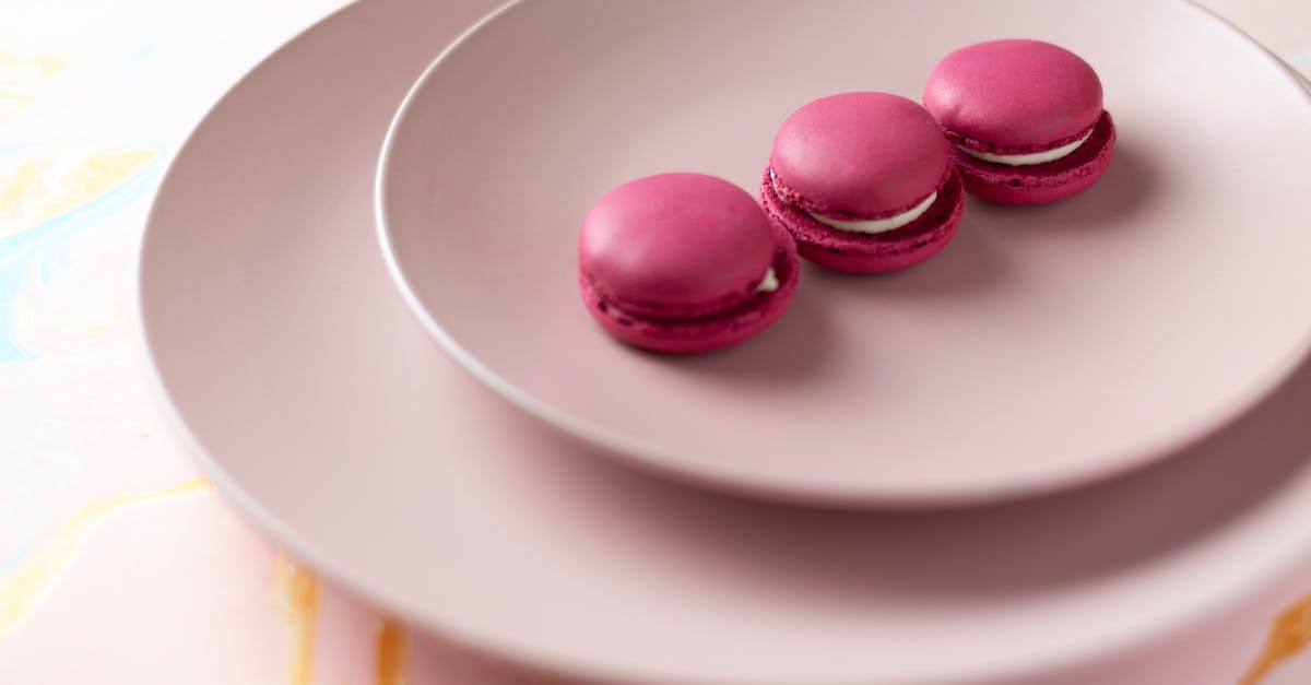 Why do French macarons need two types of sugar? - Pink Macarons on White Ceramic Plate