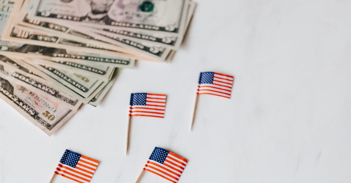 Why do fridge temperature standards between US and other countries differ? - From above of flags of United States of America on toothpicks placed near bundle of American dollars of different nominal pars on white surface of table Why do fridge temperature standards between US and other countries differ? - From above of flags of United States of America on toothpicks placed near bundle of American dollars of different nominal pars on white surface of table