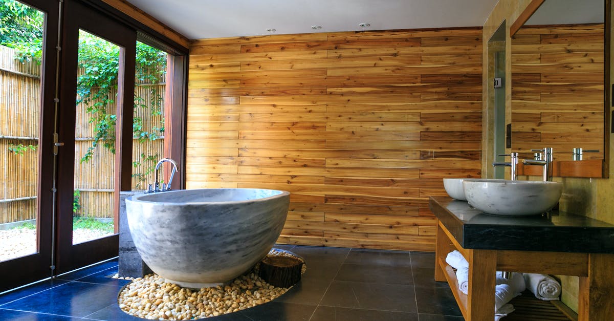 Why do I find rocks inside bags of lump charcoal? - Round White and Gray Ceramic Bathtub Inside Brown Room