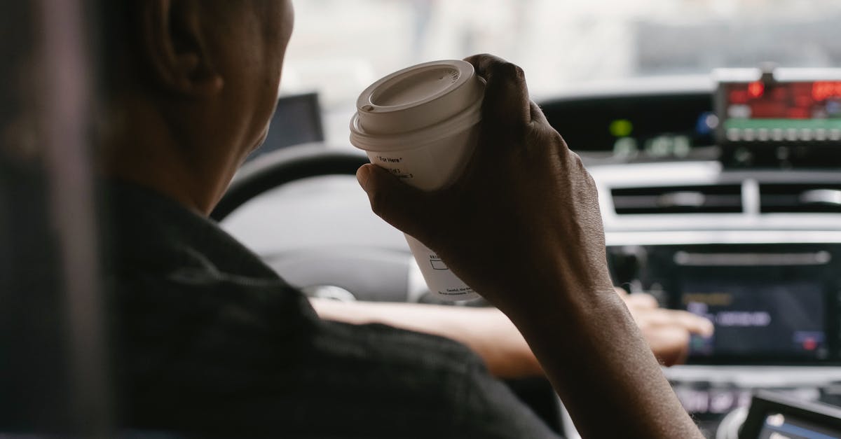 Why do industrial drinks mark caffeine as a flavoring? - Faceless driver drinking coffee while driving car Why do industrial drinks mark caffeine as a flavoring? - Faceless driver drinking coffee while driving car
