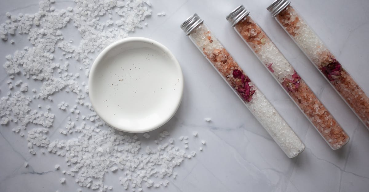 Why do salt flakes start building up in a bottle of mineral water after it was first opened? - Set of salt for bath placed on marble table Why do salt flakes start building up in a bottle of mineral water after it was first opened? - Set of salt for bath placed on marble table