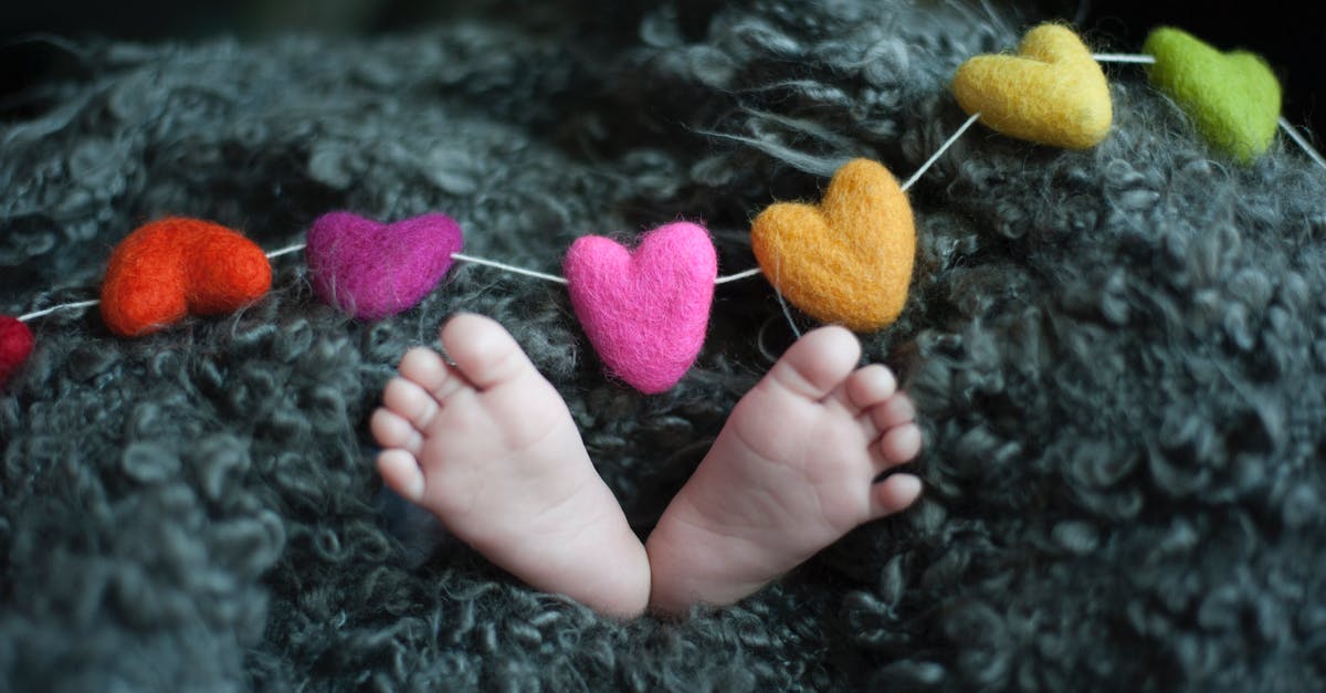 Why do some melons contain removeable dark tiny bits? - Baby's Feet Covered With Black Wool Textile Why do some melons contain removeable dark tiny bits? - Baby's Feet Covered With Black Wool Textile
