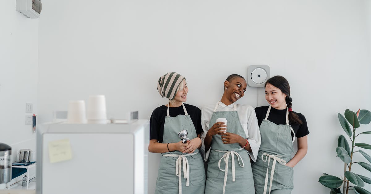 Why do some plant based milks require more emulsifiers than others? - Multiracial female baristas wearing apron standing together near wall in modern coffee shop with minimal interior during workday and looking at each other with smile Why do some plant based milks require more emulsifiers than others? - Multiracial female baristas wearing apron standing together near wall in modern coffee shop with minimal interior during workday and looking at each other with smile
