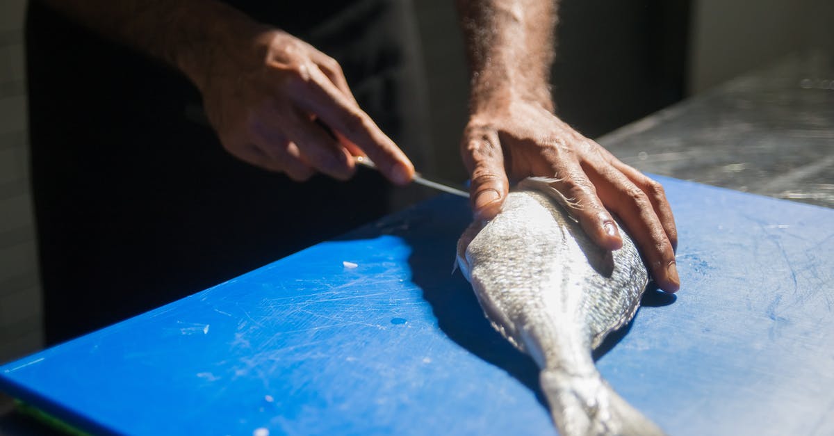 Why do some recipes recommend Kosher salt? - Person Holding White Textile on Blue Table Why do some recipes recommend Kosher salt? - Person Holding White Textile on Blue Table