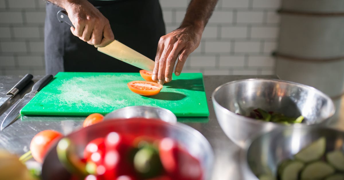 Why do some recipes recommend Kosher salt? - Person Slicing a Brown Wooden Chopping Board Why do some recipes recommend Kosher salt? - Person Slicing a Brown Wooden Chopping Board