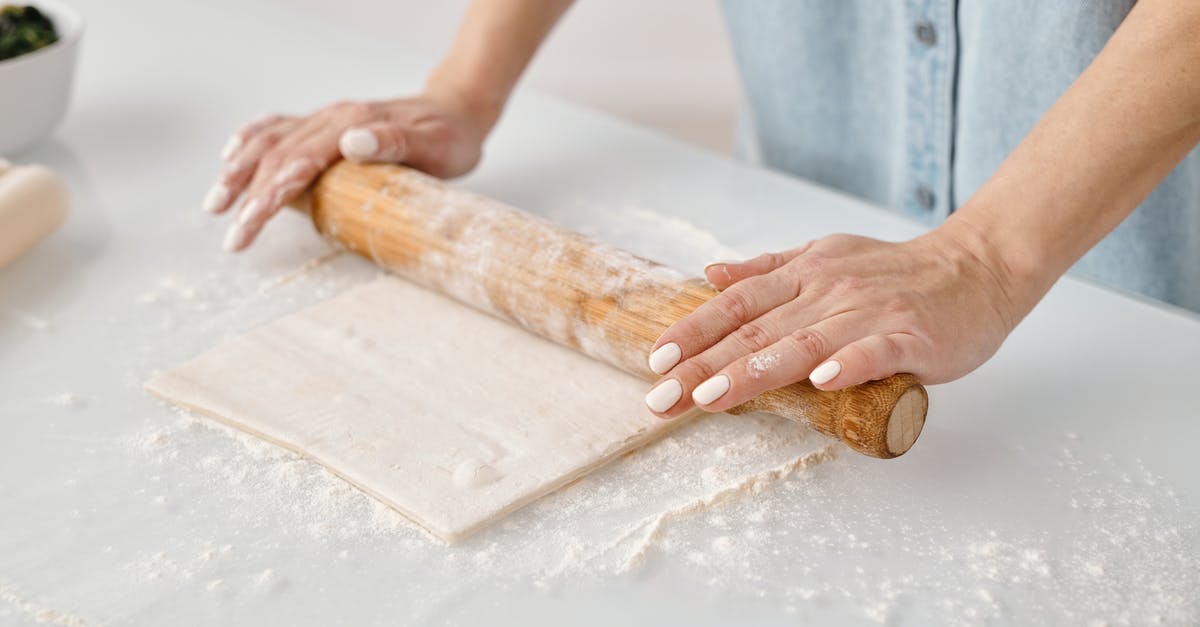 Why do some rolling pins only have one handle? - Person Flattening a Dough With Rolling Pin Why do some rolling pins only have one handle? - Person Flattening a Dough With Rolling Pin