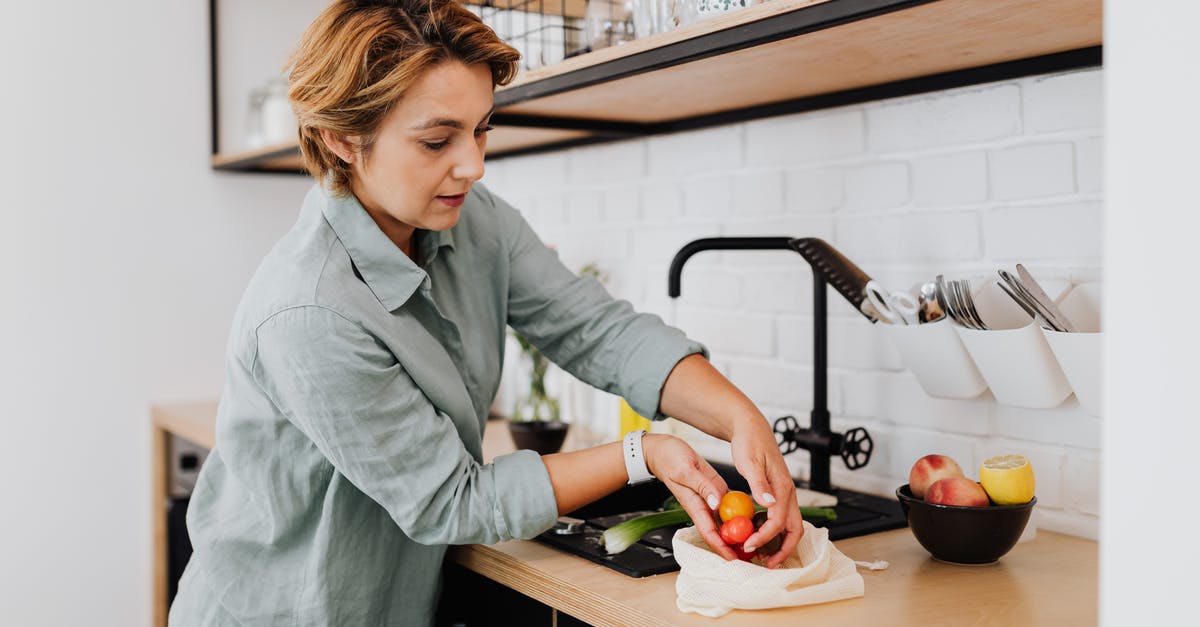 Why do they put the fruit on the bottom? - Woman in Gray Long Sleeve Shirt Holding Green Vegetable Why do they put the fruit on the bottom? - Woman in Gray Long Sleeve Shirt Holding Green Vegetable