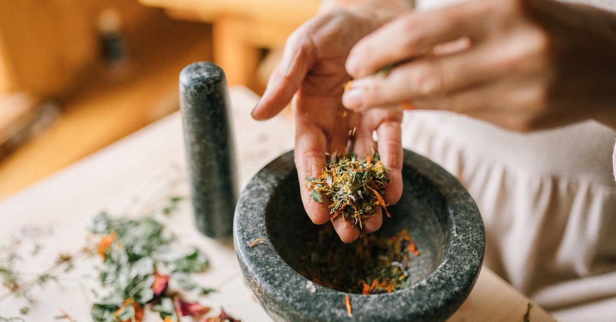 Why do we boil whole spices when making masala tea? - Person Holding Green Plant in Gray Pot Why do we boil whole spices when making masala tea? - Person Holding Green Plant in Gray Pot