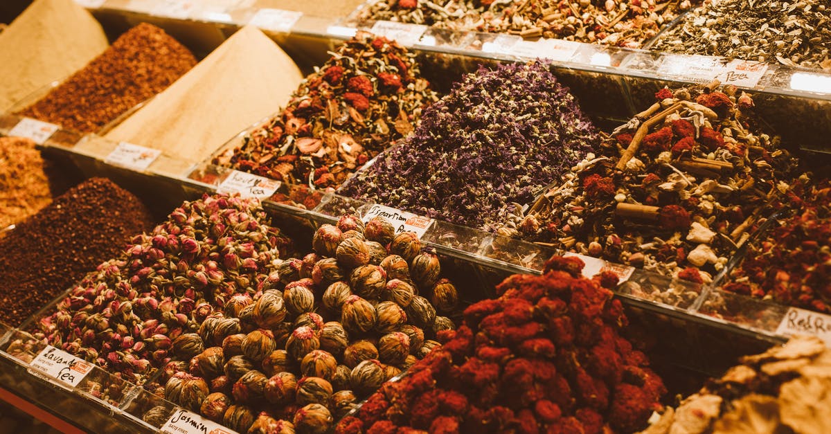 Why do we boil whole spices when making masala tea? - Containers Full of Spices on a Market StallĀ Why do we boil whole spices when making masala tea? - Containers Full of Spices on a Market StallĀ