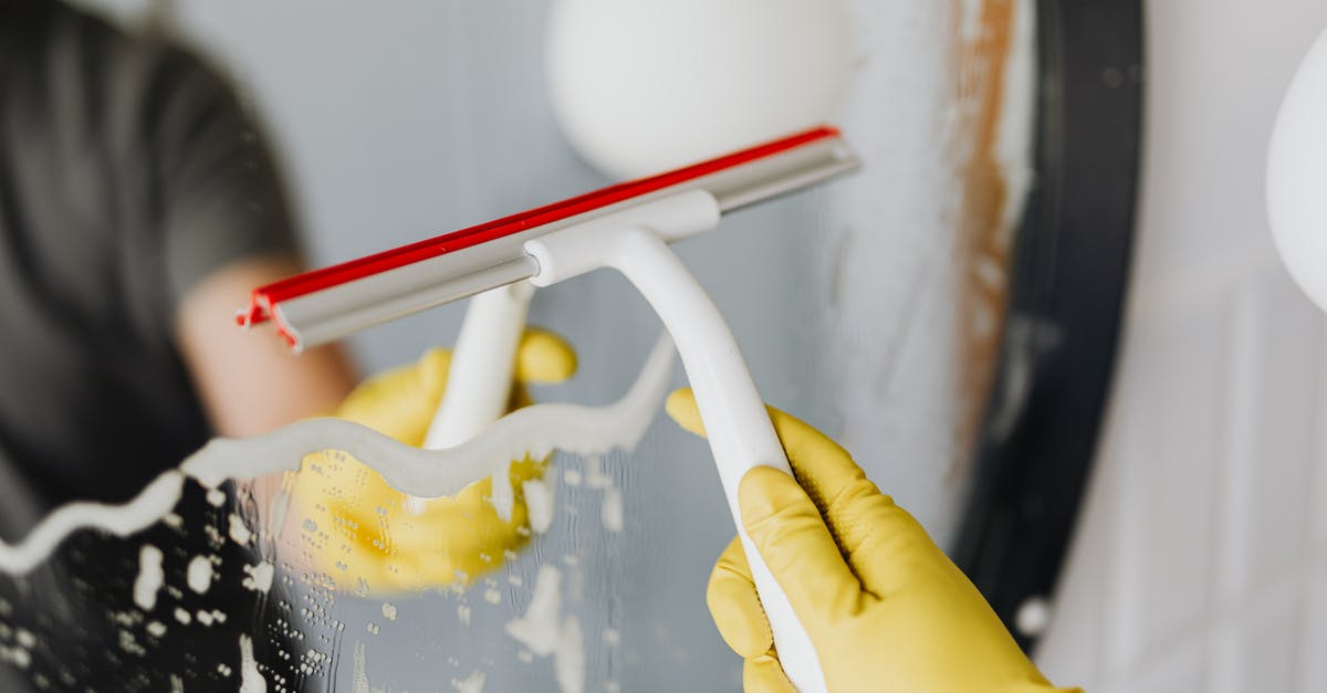 Why do we remove the foam from soymilk while it boils while preparing it? - Anonymous person drying mirror with squeegee