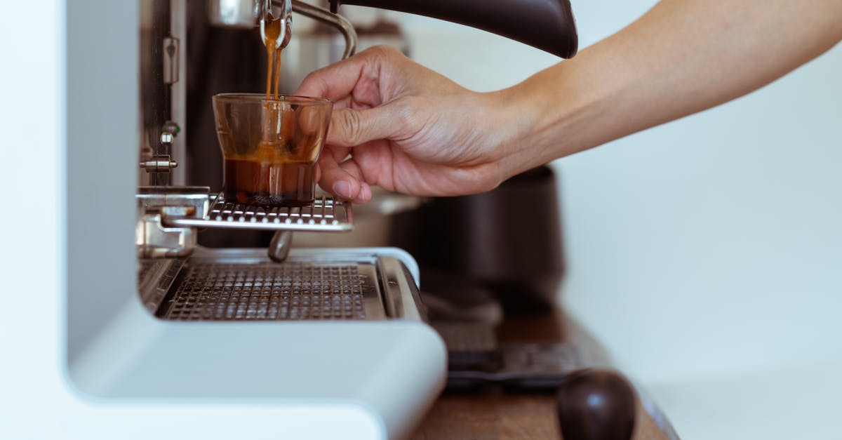 Why does a portafilter machine take so long to warm up and a modern machine doesn't? - Crop barista making coffee in coffeemaker Why does a portafilter machine take so long to warm up and a modern machine doesn't? - Crop barista making coffee in coffeemaker