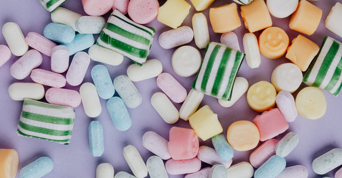 Why does adding sugar to sour things cause them not to be sour? - Multicolored sweets on light purple background Why does adding sugar to sour things cause them not to be sour? - Multicolored sweets on light purple background