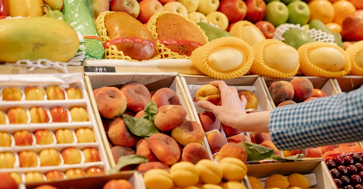Why does apples bought at the market feel sticky? - A Person Holding a Fruit Why does apples bought at the market feel sticky? - A Person Holding a Fruit