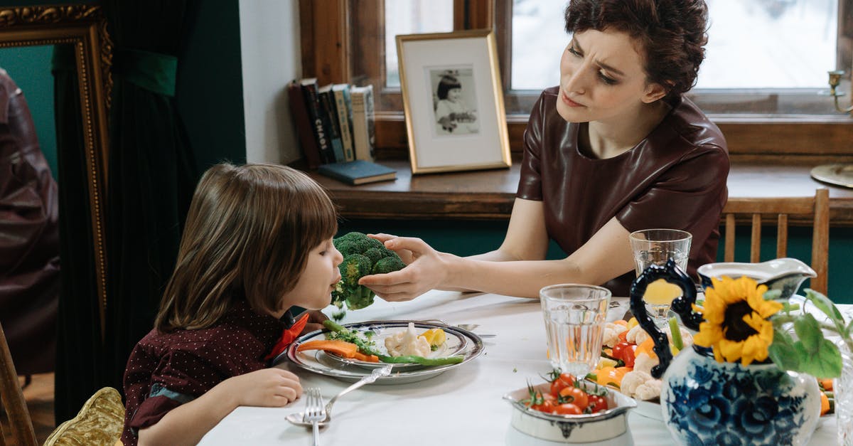 Why does broccoli turn brown when steaming? - A Mother and Child Having a Healthy Dinner