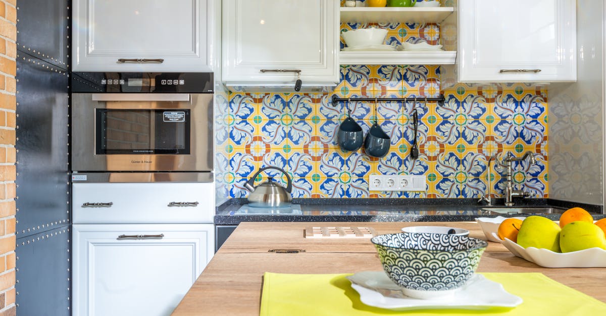Why does Chinese food reheats better on stove than in microwave? - Table with bowl in kitchen Why does Chinese food reheats better on stove than in microwave? - Table with bowl in kitchen