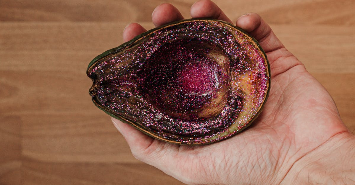 Why does food spoil in the freezer? - Man showing rotten avocado with pink glitter Why does food spoil in the freezer? - Man showing rotten avocado with pink glitter