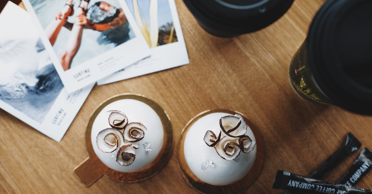 Why does instant coffee have less caffeine? - Coconut sweets and takeaway coffee on table of modern cafe Why does instant coffee have less caffeine? - Coconut sweets and takeaway coffee on table of modern cafe