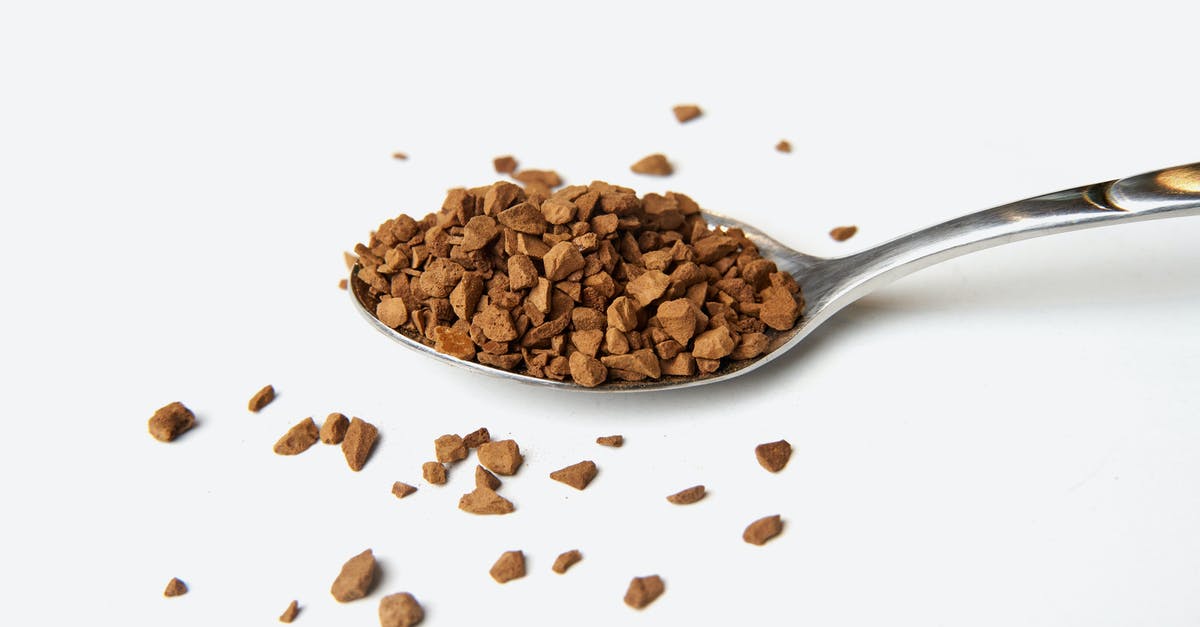 Why does instant coffee have less caffeine? - Brown Coffee Powder on Silver Spoon Why does instant coffee have less caffeine? - Brown Coffee Powder on Silver Spoon