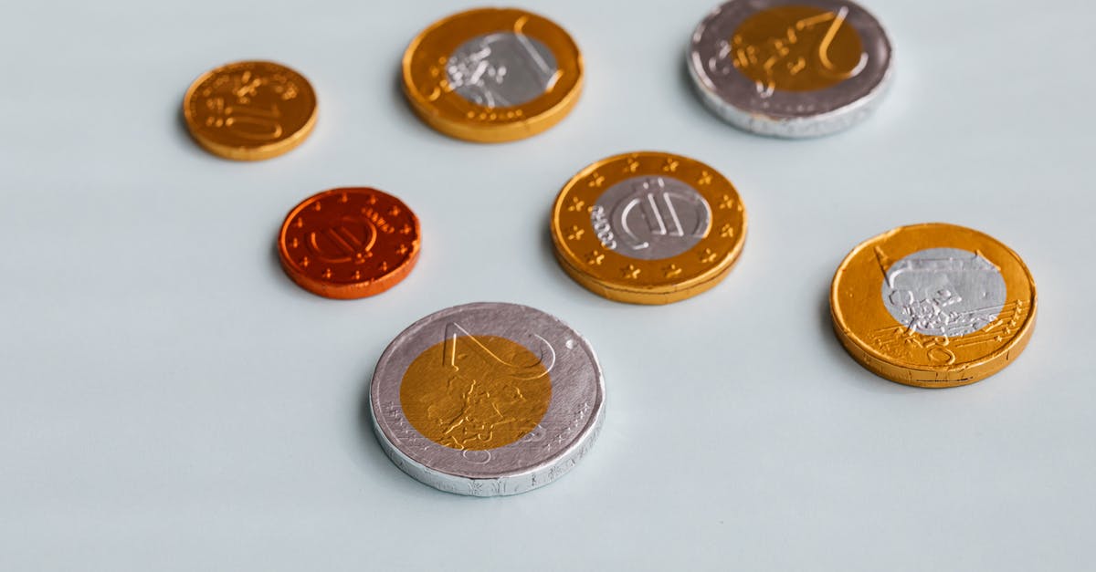 Why does milk and white chocolate have different tempering temperatures? - Set of chocolate euro coins on table Why does milk and white chocolate have different tempering temperatures? - Set of chocolate euro coins on table