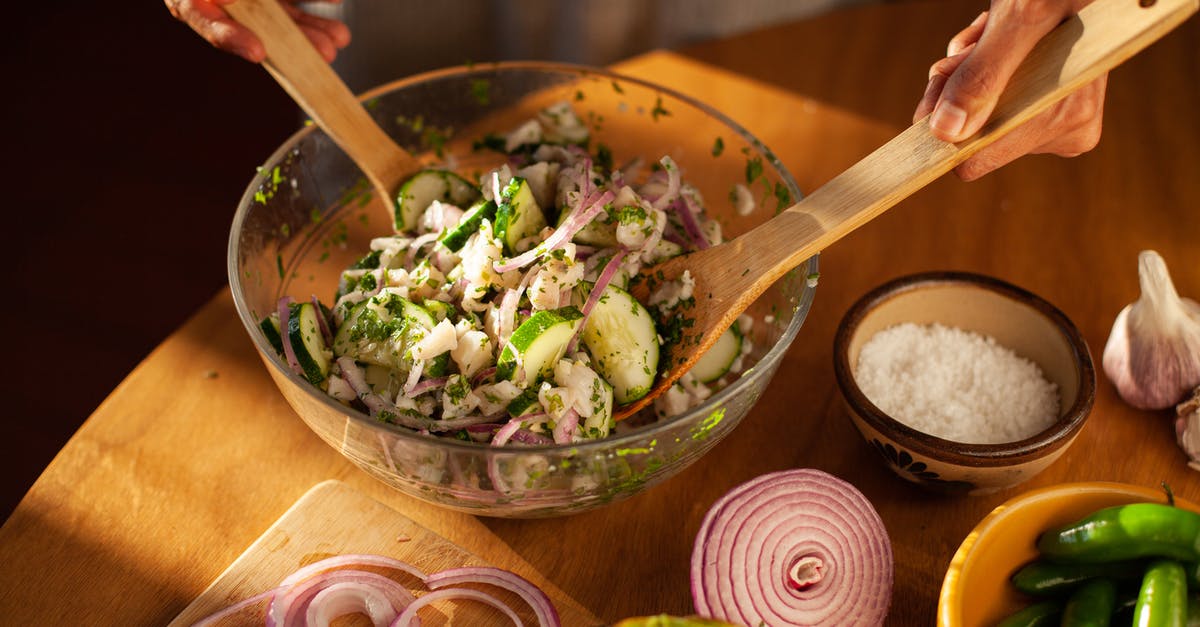 Why does mixing the salt and yeast sometimes work? - A Person Mixing Salad using Wooden Spoons