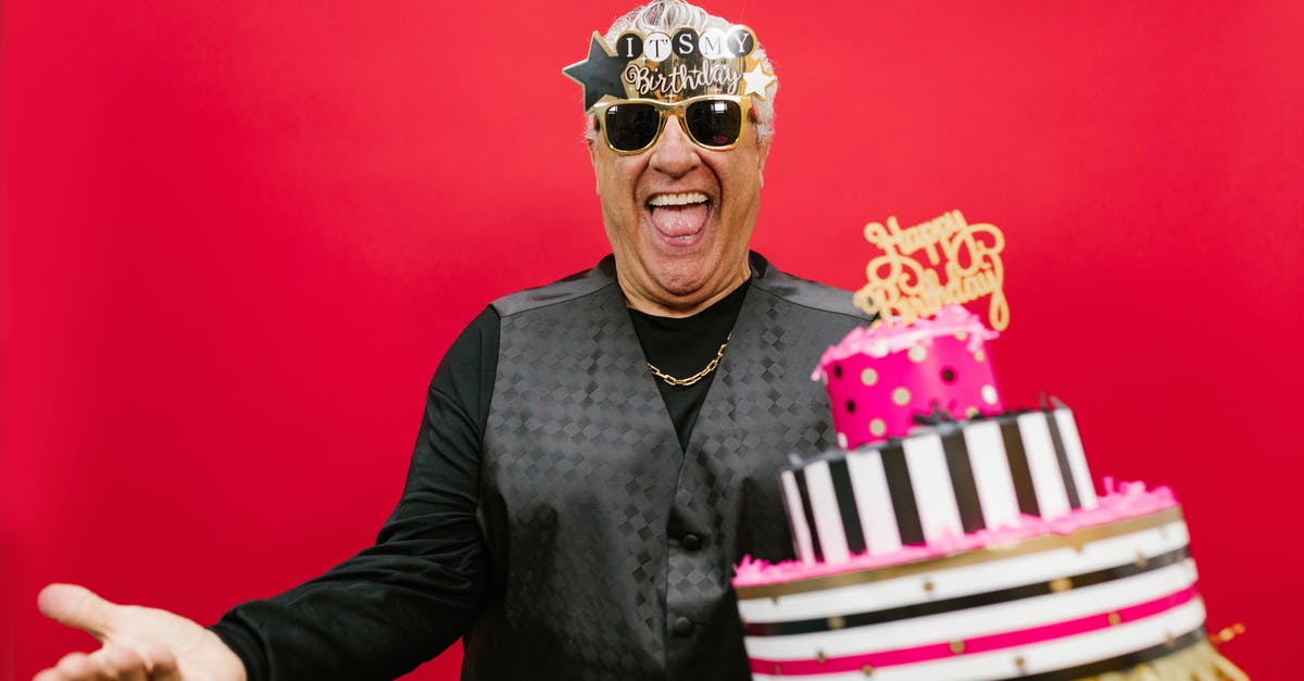 Why does my cake have to be inverted? Why a 2-layer appearance? - A Man Holding his Birthday Cake