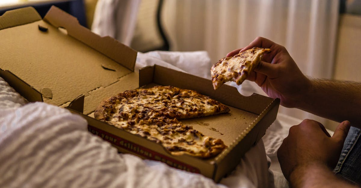 Why does my ricotta cheese go bad in a few days? - Faceless man enjoying delicious pizza lying in bed at home Why does my ricotta cheese go bad in a few days? - Faceless man enjoying delicious pizza lying in bed at home