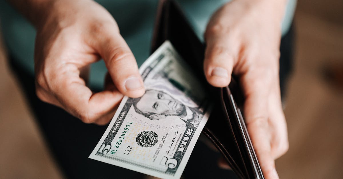 Why does soymilk take longer to expire? - Unrecognizable man holding wallet with money Why does soymilk take longer to expire? - Unrecognizable man holding wallet with money