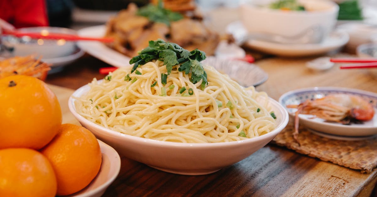 Why does the carbs / fiber ratio decrease after cooking? - Tasty cooked noodles with fresh parsley leaves between prawn and ripe oranges on table in house